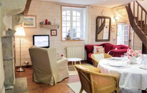 a living room with a table and a couch at Nice Home In Auxais With Kitchenette in Auxais