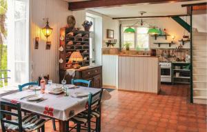 a kitchen with a table and chairs in a room at Awesome Home In La Fort Fouesnant With 2 Bedrooms in La Forêt-Fouesnant