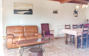 sala de estar con sofá de cuero y mesa en Amazing Home In La Faute Sur Mer With Kitchen, en La Faute-sur-Mer