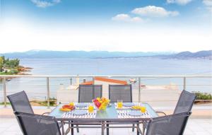a table with a bowl of fruit on a balcony at 3 Bedroom Lovely Home In Chalkida in Chalkida