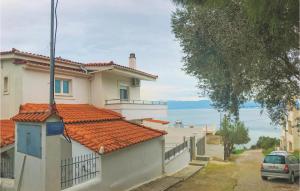 a house with a car parked in front of it at 3 Bedroom Lovely Home In Chalkida in Chalkida