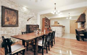 a dining room with a wooden table and chairs at Cozy Home In Pakostane With Kitchen in Pakoštane