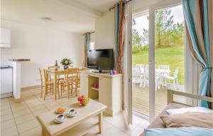 a living room with a television and a table at Le Hameau De Peemor Pen in Morgat