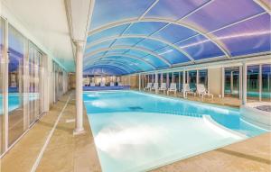 a large swimming pool with a domed ceiling at Le Hameau De Peemor Pen in Morgat