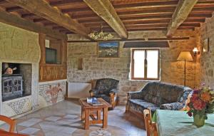 a living room with a couch and a table at Stunning Home In La-Chapelle-Saint-Jean in La Chapelle-Saint-Jean