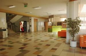 an empty lobby with a potted plant in a building at Koleje J.A.Komenského in Brno