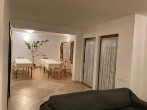 a living room with a table and a dining room at Casa Ambasadorului in Bran