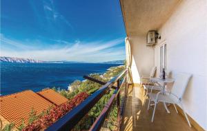 a balcony with a view of the ocean at Nice Apartment In Senj With House Sea View in Senj