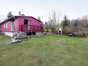 a pink house with a bench in a yard at Quaint Holiday Home in G ntersberge near Lake in Güntersberge