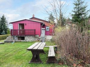 a picnic bench in front of a pink building at Quaint Holiday Home in G ntersberge near Lake in Güntersberge