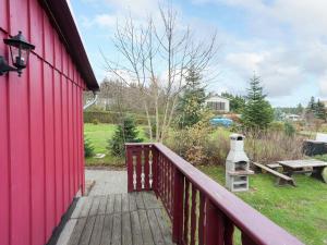 a red house with a wooden deck with a picnic table at Quaint Holiday Home in G ntersberge near Lake in Güntersberge