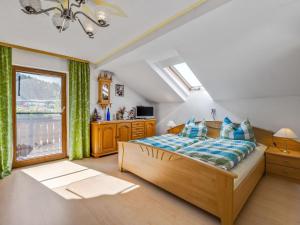 a bedroom with a large bed and a window at Bauernhof in Spandlberg am Hohe Bogen in Neukirchen beim Heiligen Blut
