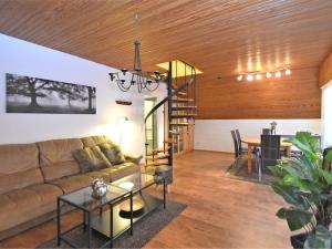 a living room with a couch and a table at Classy Holiday Home in Wolfshagen with Fenced Garden in Hahnenklee-Bockswiese