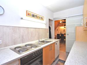 a kitchen with a sink and a stove at Classy Holiday Home in Wolfshagen with Fenced Garden in Hahnenklee-Bockswiese