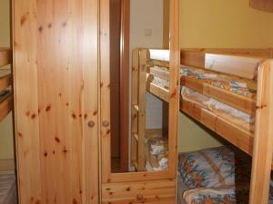 a room with two bunk beds and a mirror at Apartment with private terrace in H ddingen in Bad Wildungen