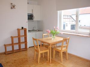 a kitchen and dining room with a table and chairs at Apartment with private terrace in H ddingen in Bad Wildungen