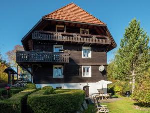 a large house with a balcony on top of it at Cozy holiday apartment in the Black Forest in Dachsberg im Schwarzwald