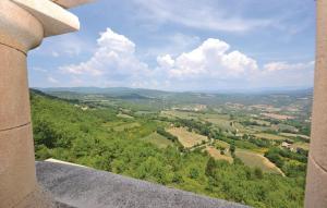 a view of a valley from a ledge of a building at 1 Bedroom Lovely Home In Viens in Viens