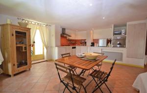 a kitchen with a wooden table and some chairs at 1 Bedroom Lovely Home In Viens in Viens