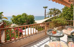 a balcony with tables and chairs and the ocean at 5 Bedroom Nice Home In Santa Pola in Santa Pola