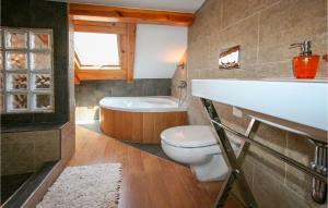 a bathroom with a toilet and a sink and a tub at 5 Bedroom Nice Home In Santa Pola in Santa Pola