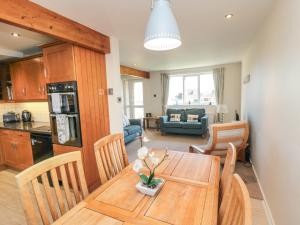 a kitchen and dining room with a wooden table and chairs at Number Six in Burniston