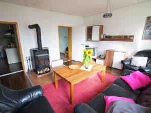 a living room with a table and a wood stove at Spacious holiday home in Hesse with garden in Waldeck