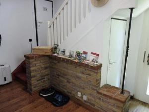 uma lareira de tijolos numa sala de estar com uma escadaria em Holiday home with terrace in Sauerland em Brilon