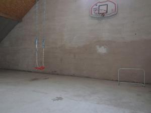 an empty gym with a basketball hoop on the wall at Chic Holiday Home in Liesen with Garden in Hallenberg