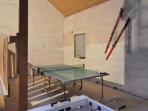 a ping pong table in a room with a wall at Chic Holiday Home in Liesen with Garden in Hallenberg