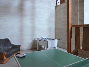a living room with a ping pong table and a couch at Chic Holiday Home in Liesen with Garden in Hallenberg