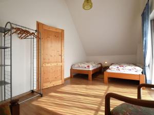 a room with two beds and a door at Countryside apartment with garden in Schallstadt
