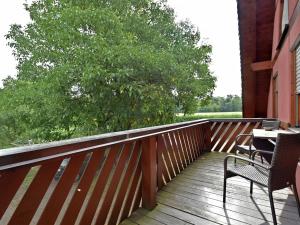 a wooden deck with two chairs and a table on it at Countryside apartment with garden in Schallstadt