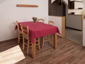 a table with a red table cloth on it in a kitchen at Apartment in a quiet location with balcony in Herrischried