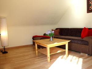 a living room with a couch and a coffee table at Apartment in a quiet location with balcony in Herrischried