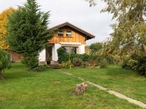 a house in a yard with a tree at Holiday home in the Thuringian Forest in Wutha-Farnroda