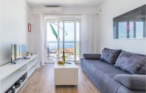 a living room with a couch and a view of the ocean at Lovely Apartment In Dramalj With Wifi in Dramalj