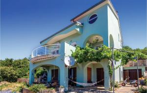 a blue house with a tree in front of it at Lovely Apartment In Dramalj With Wifi in Dramalj