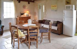 a kitchen and dining room with a table and chairs at Nice Home In La Cambe With Kitchen in La Cambe