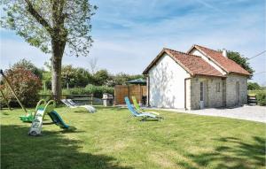 a group of lawn chairs sitting in the grass at Nice Home In La Cambe With Kitchen in La Cambe