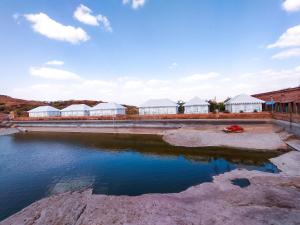 a body of water with buildings in the background at Bijolai Palace - A Inde Hotel , Jodhpur in Jodhpur