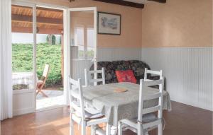 a dining room with a table and chairs and a couch at Two-Bedroom Holiday Home In La Tranche-Sur-Mer in La Tranche-sur-Mer