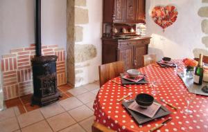 a dining room with a table and a wood stove at Amazing Home In Granges Dans With 2 Bedrooms, Wifi And Outdoor Swimming Pool in Granges-dʼAns