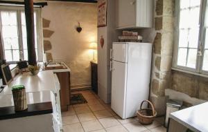 a kitchen with a white refrigerator in a room at Amazing Home In Granges Dans With 2 Bedrooms, Wifi And Outdoor Swimming Pool in Granges-dʼAns