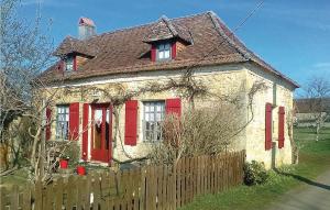 a small house with red doors and a wooden fence at Awesome Home In Granges D'ans in Granges-dʼAns
