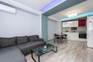 a living room with a couch and a table at Harmony Residence in Bucharest