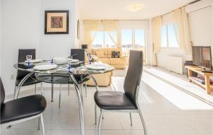 a living room with a dining room table and chairs at Beautiful Apartment In Rivera Del Sol With 2 Bedrooms, Wifi And Outdoor Swimming Pool in La Cala de Mijas