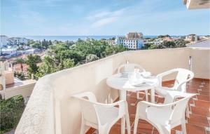 a table and chairs on a balcony with a view of the ocean at Nice Apartment In Rivera Del Sol in La Cala de Mijas