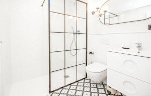 a white bathroom with a shower and a toilet at Nice Apartment In Rivera Del Sol in La Cala de Mijas