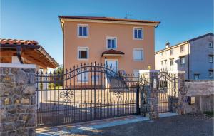 a gate in front of a house at Nice Apartment In Cavle With 2 Bedrooms And Wifi in Čavle